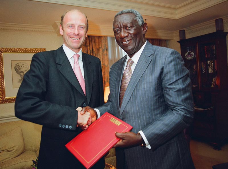 Rupert Goodman, Chairman of FIRST presents a leather-bound copy of the Ghana Report to HE John Agyekum Kufuor, President of the Republic of Ghana