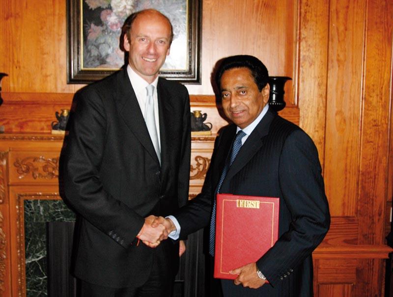 Rupert Goodman, Chairman and Founder of FIRST presents a leather-bound copy of the Special India report to Kamal Nath