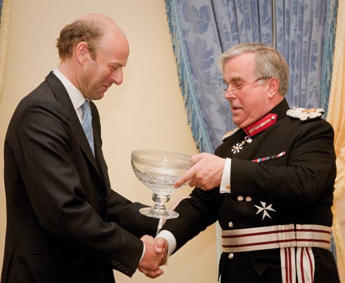 Rupert Goodman, Chairman and Founder of FIRST receives the Queen's Award Bowl from Sir David Brewer MG JP, Her Majesty's Lord-Lieutenant of Greater London