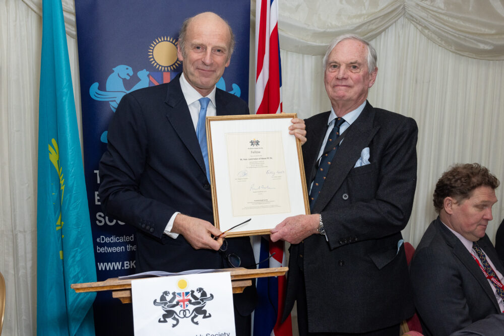 Rt Hon Lord Astor of Hever PC DL receives the Fellowship of the British-Kazakh Society from Rupert Goodman OBE DL